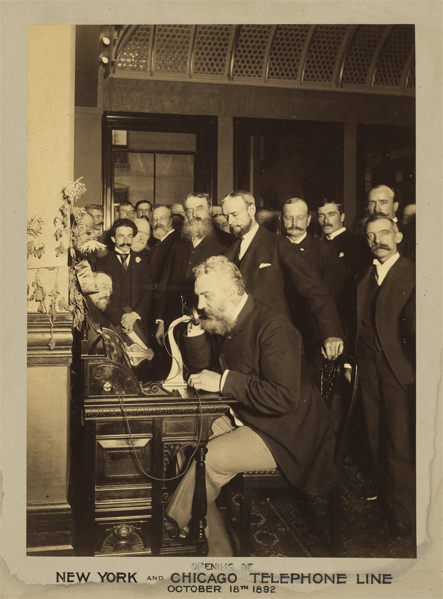 photo of alexander graham bell at a telegraph machine